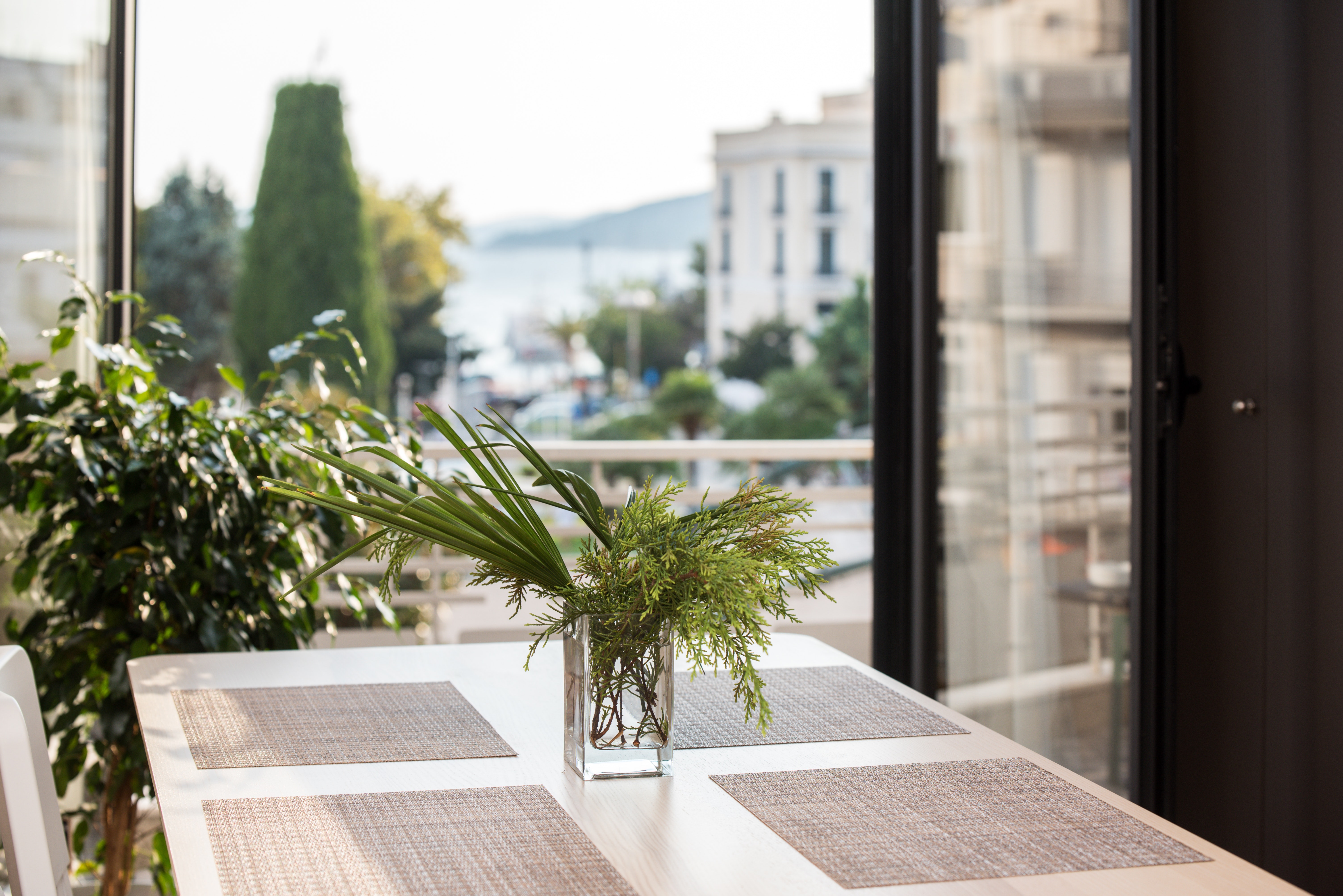 sustainable planting on balcony with chair and table for dining